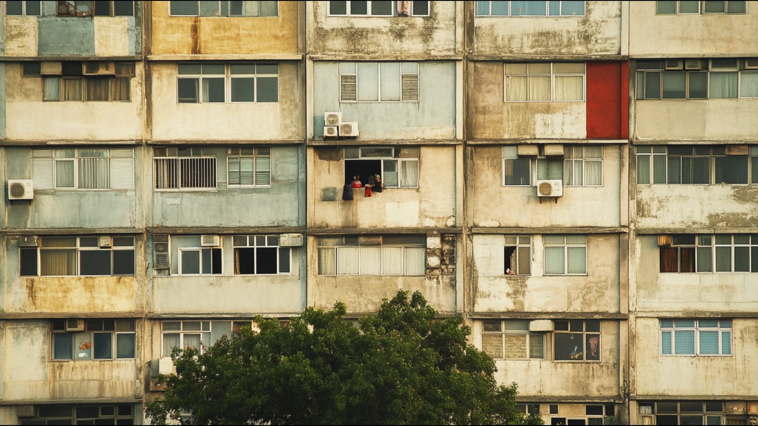 AI-generated hero image: Dense urban neighborhood under extreme heat, concrete apartment blocks with sharp shadows, thermal haze, figures seeking shade